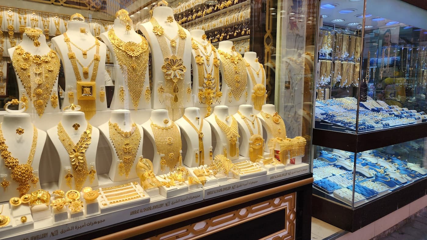 Gold jewellery display cabinets lining the showroom wall